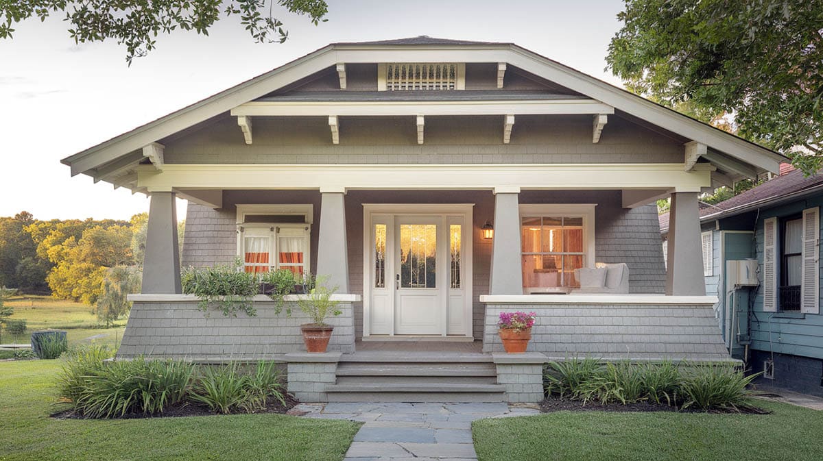 Gray painted bungalow with trim in white