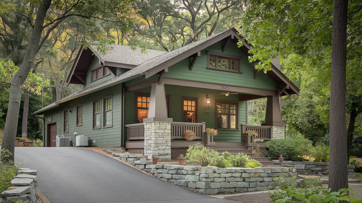 American craftsman bungalow house painted in forest green with dark brown trim 