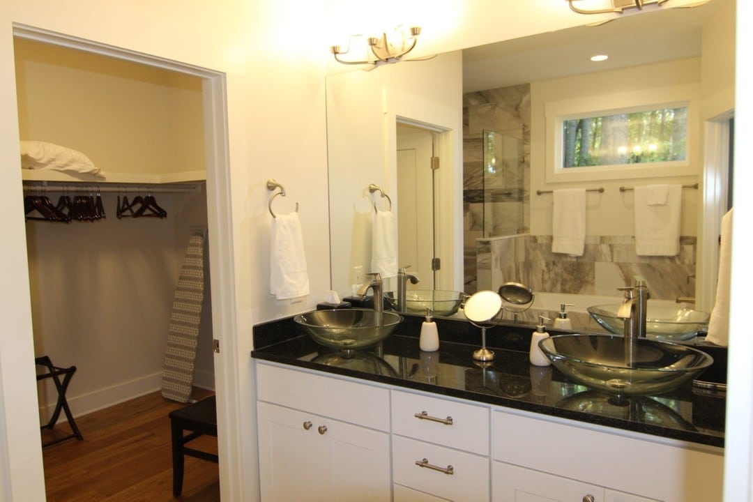 Bathroom with large closet and vanity with double basin sinks