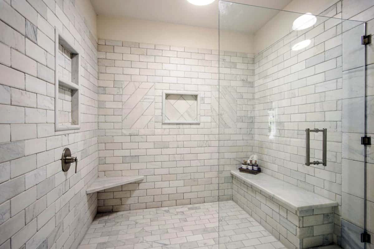 Shower with bench and marble field tile