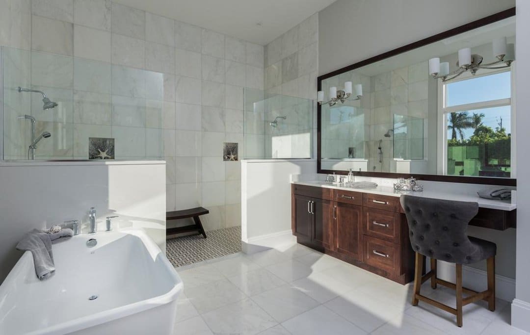 Bathroom with dark cabinet vanity and large mirror