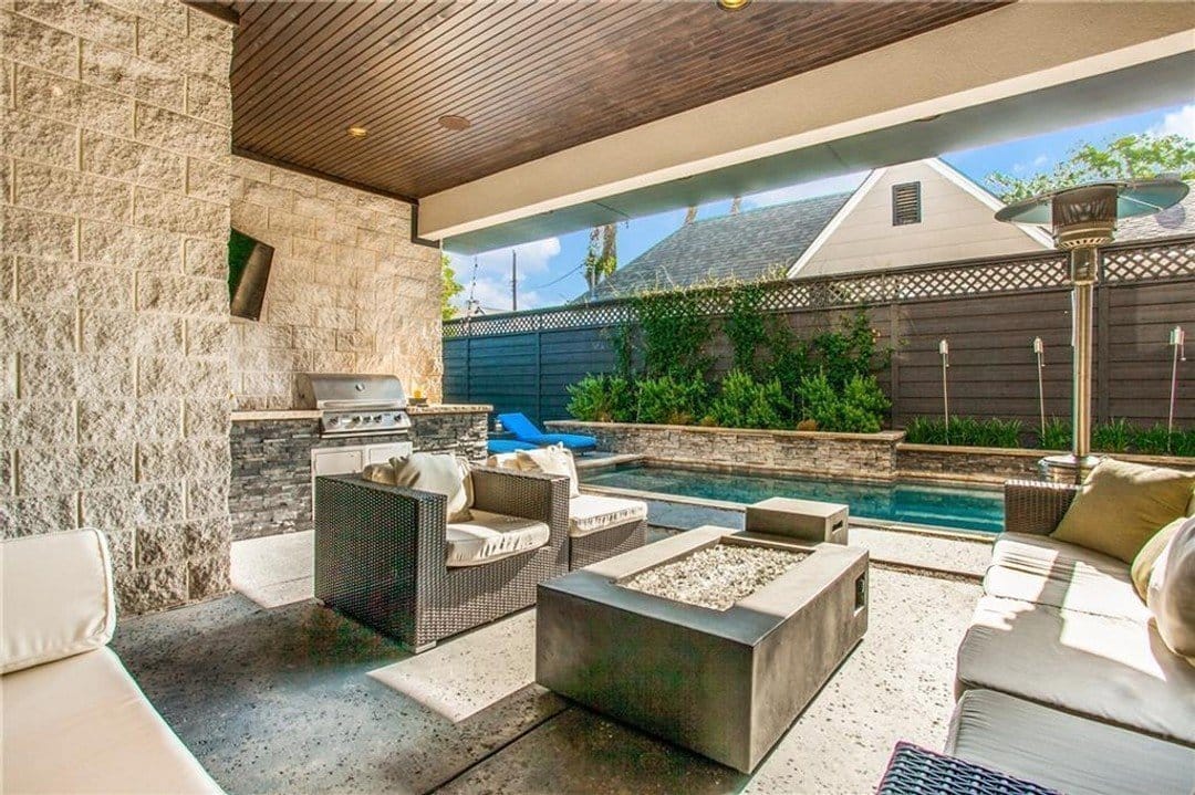 Luxury covered patio with pool views, fire pit and outdoor kitchen