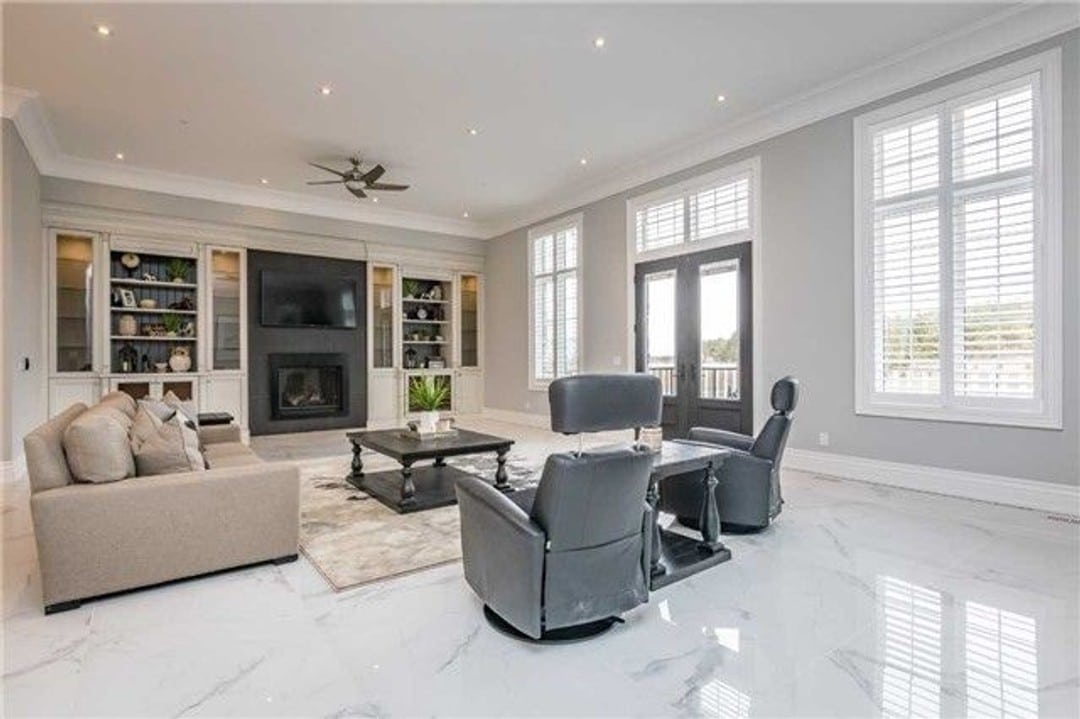 Family room with central fireplace with built-in storage cabinets