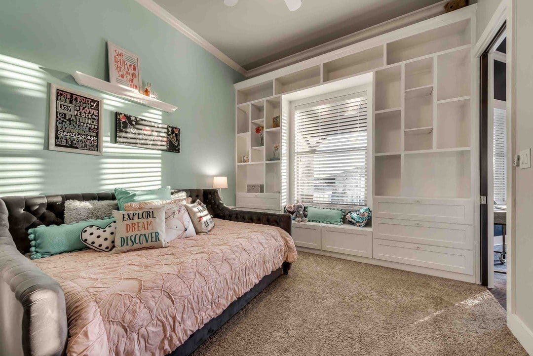 Beautifully designed girls bedroom with built-in shelves