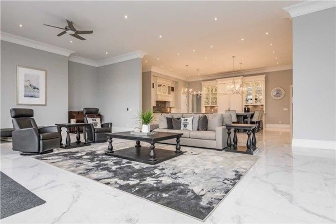 Open concept great room with polished marble floors