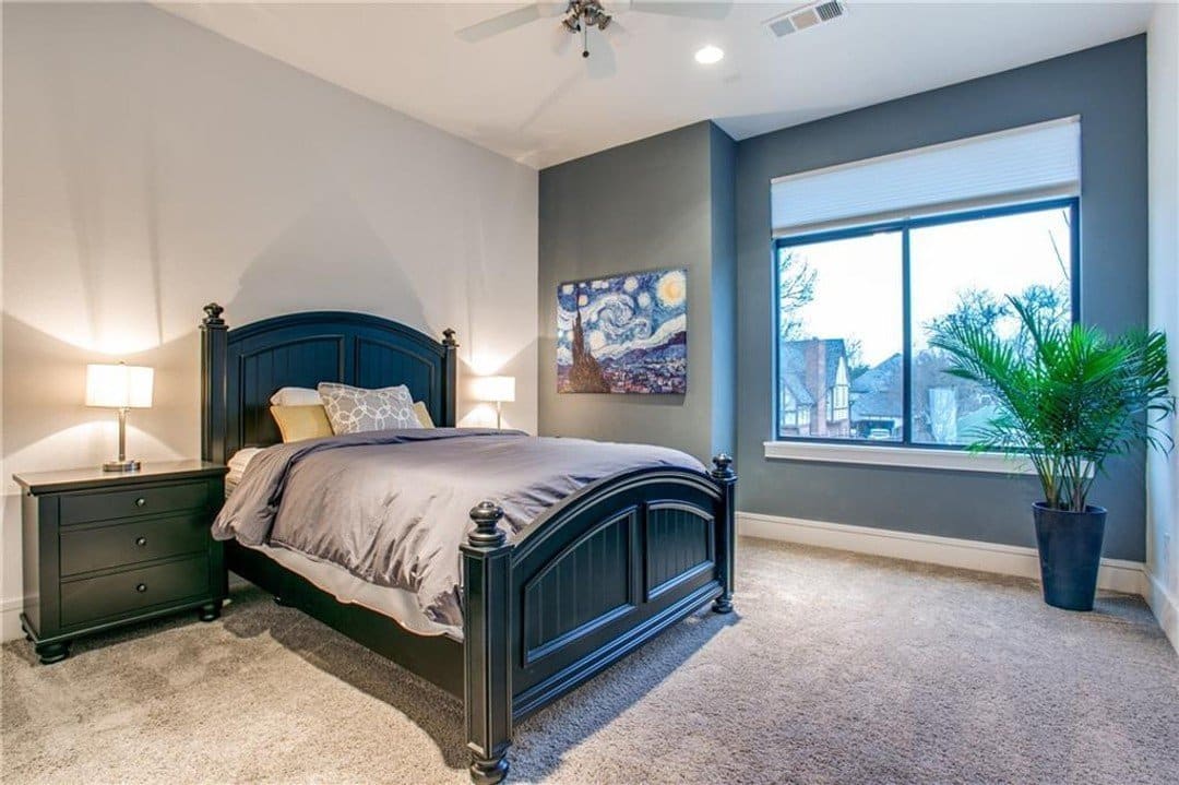 Guest bedroom with carpet and large window