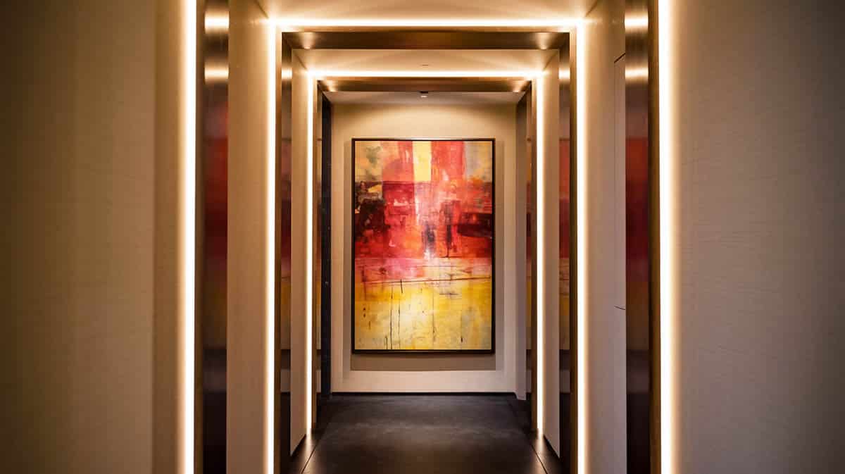 Hallway with art and recessed lighting