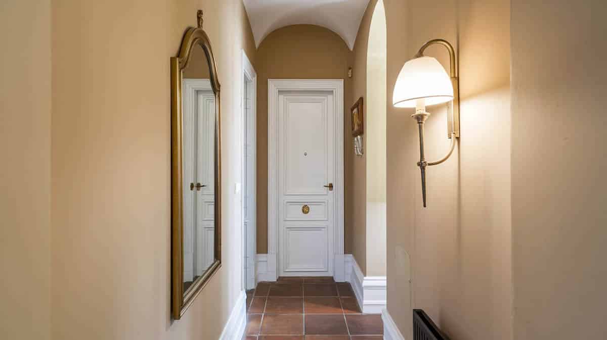 Hallway with mirror and sconce light