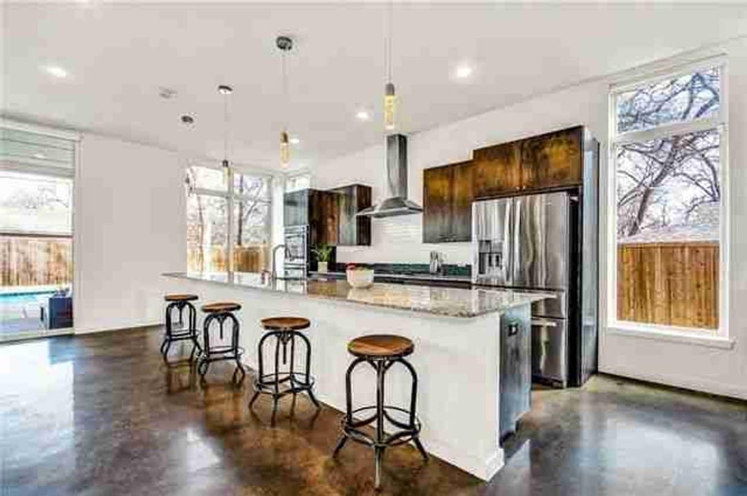 Contemporary two-tone kitchen with long dining island