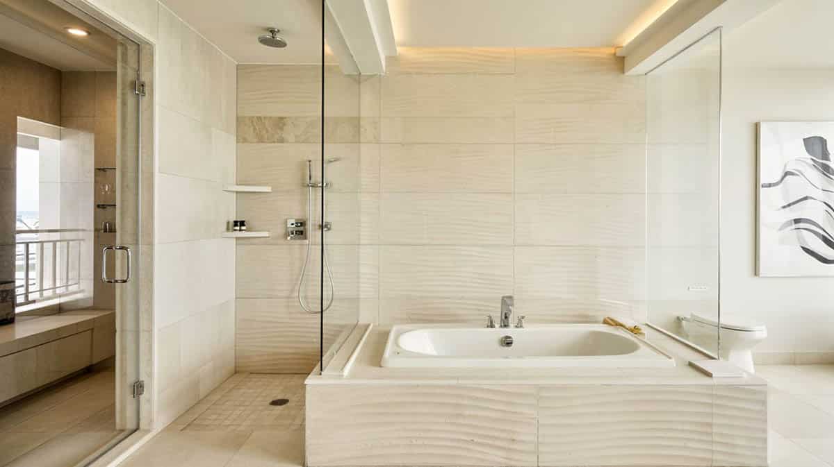 Bathroom with cream textured tiles in the shower and tub
