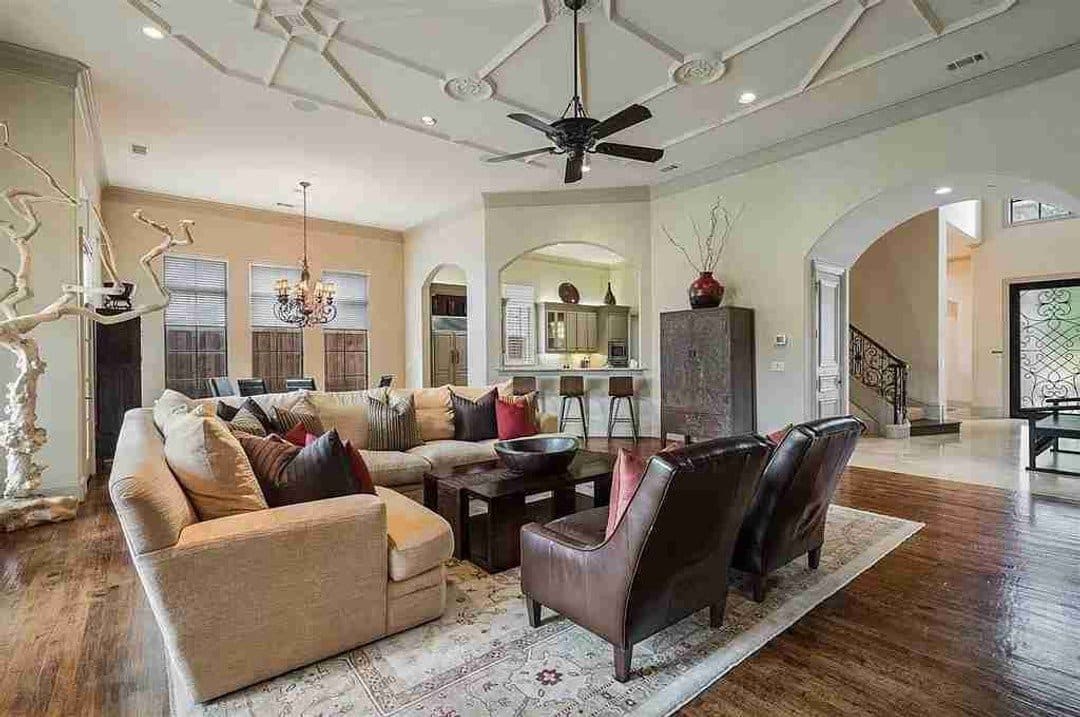 Mediterranean living area with open plan and decorative raised ceiling details