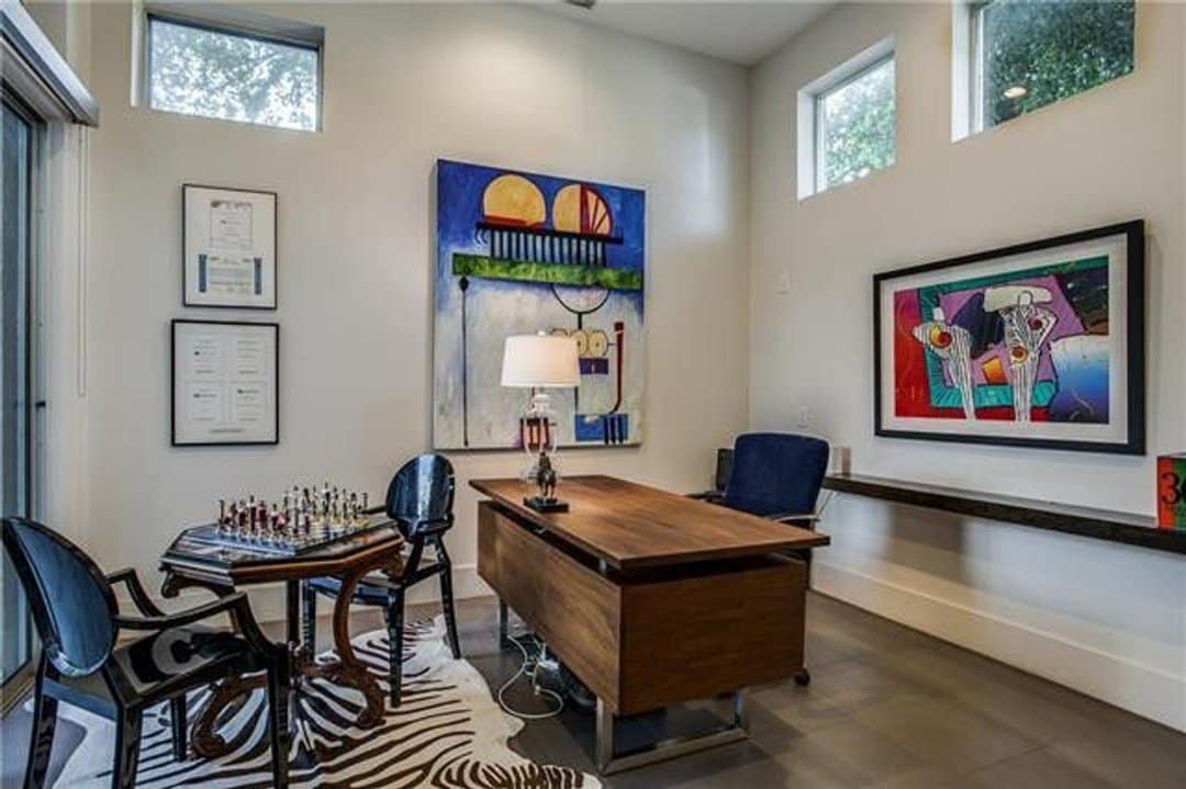 Stylish home office with high clerestory windows and views to patio