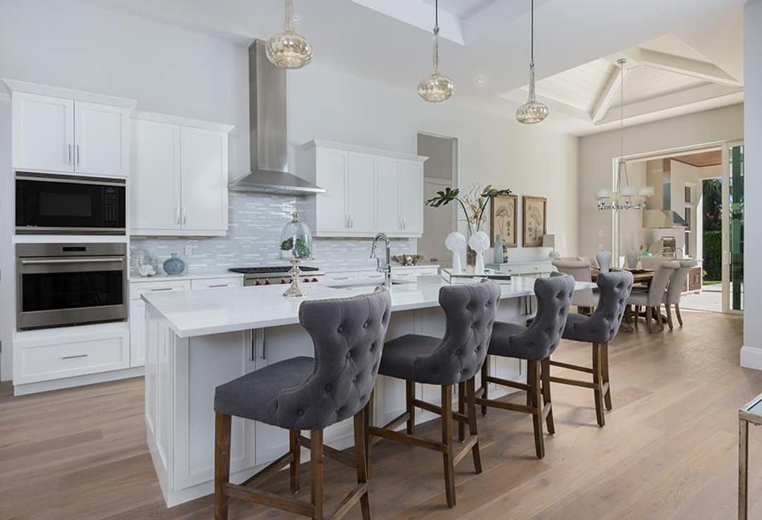 Open plan kitchen and dining with white shaker cabinetry