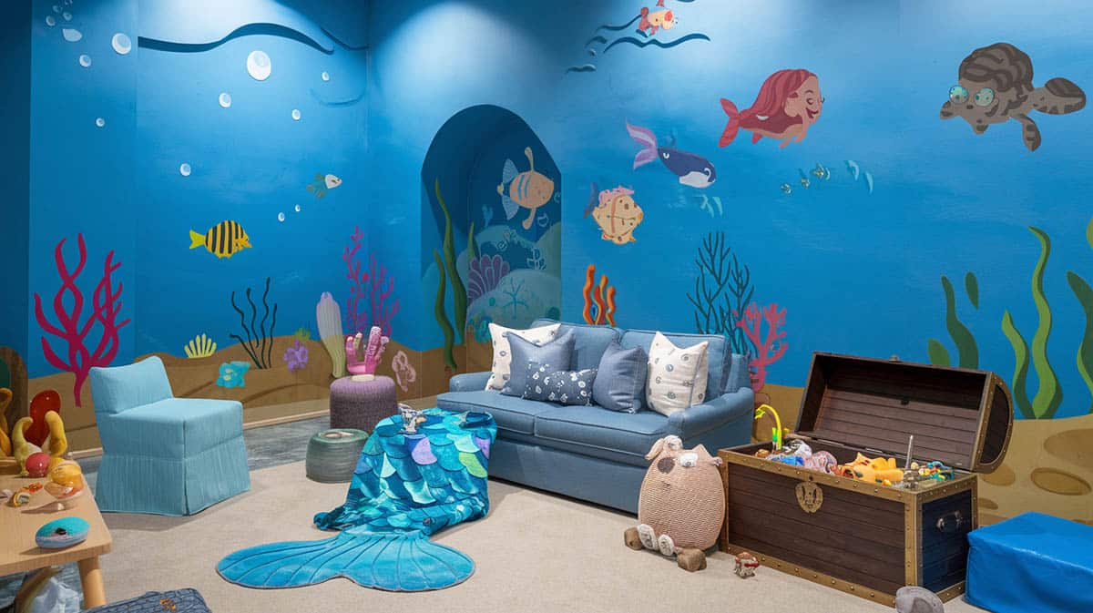 Playroom with underwater wonderland theme with blue underwater mural and sea creatures