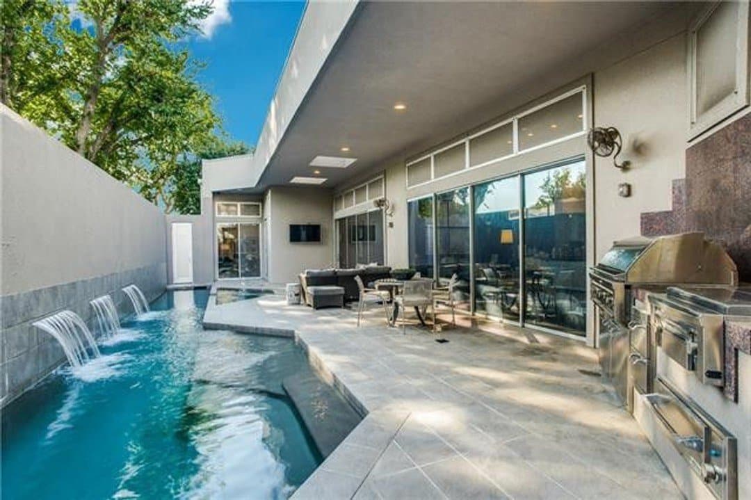 Pool patio with waterfalls and outdoor kitchen