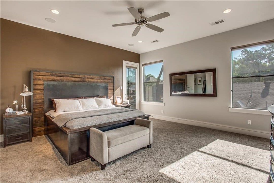 Primary bedroom with brown accent wall and attached bathroom