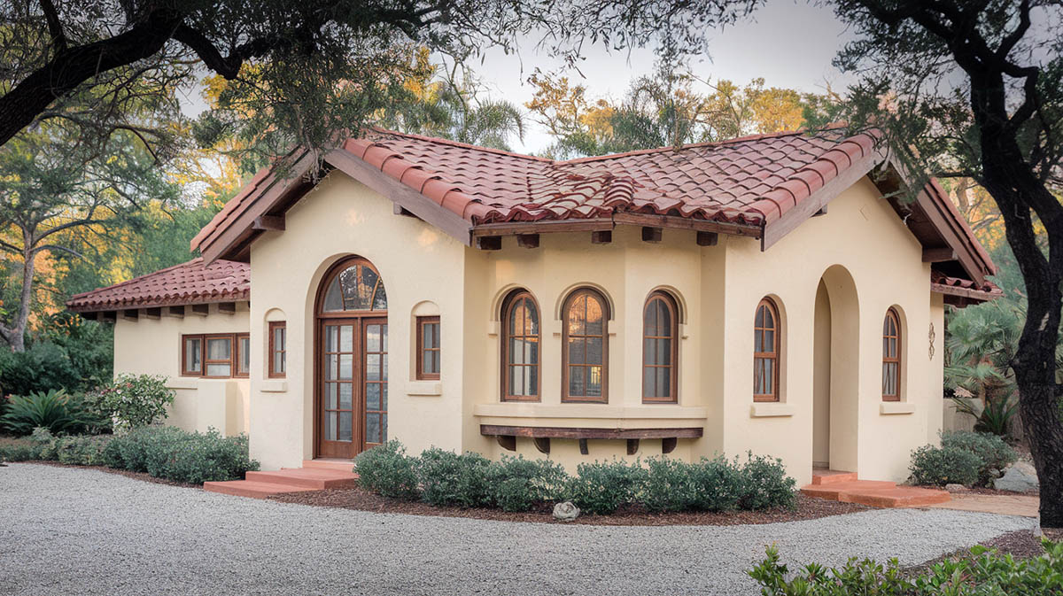 Spanish colonial bungalow with a soft cream exterior and red roof tiles