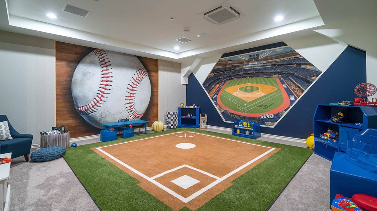 Sports stadium playroom with baseball wall art and baseball diamond turf rug