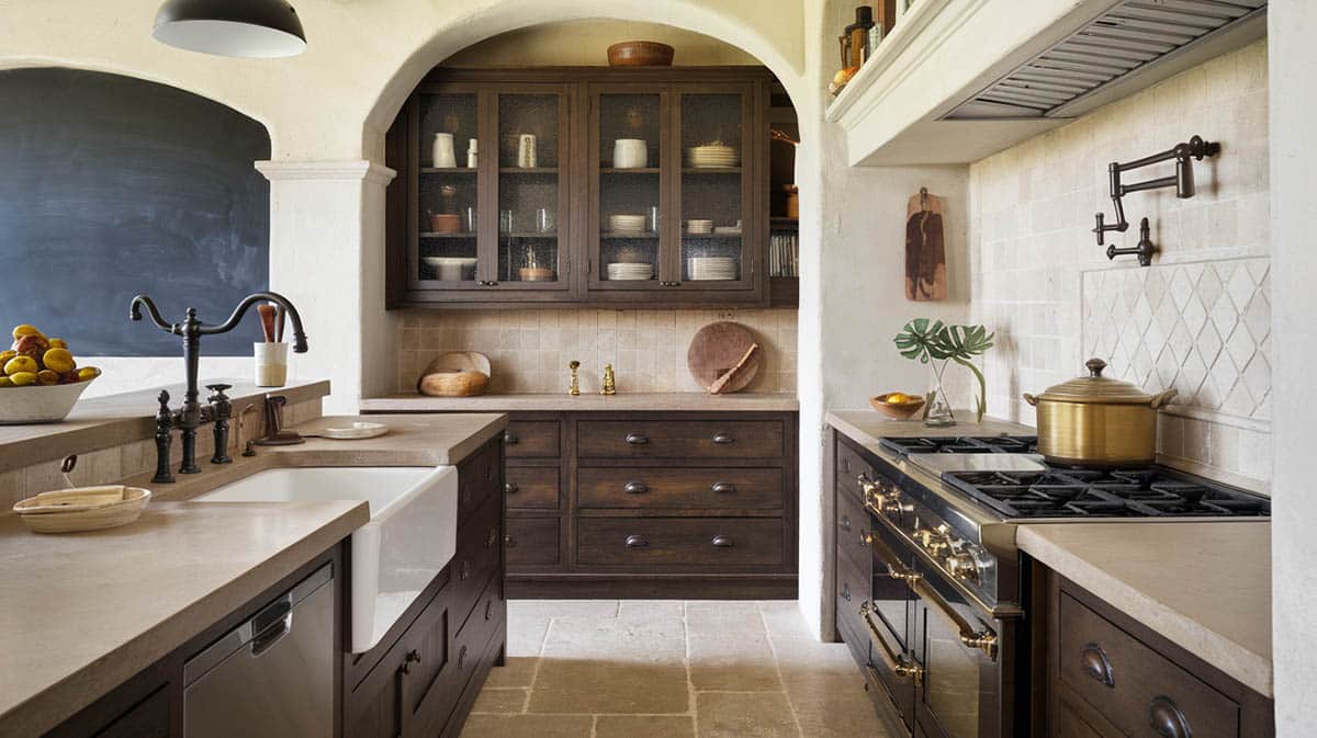 Tuscan kitchen with backsplash tile and floors and deep rich cabinets with glass doors