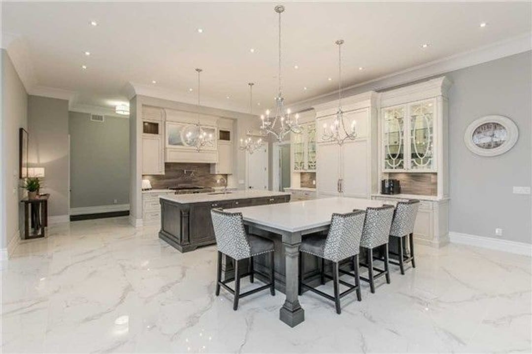 Elegant kitchen with chandeliers and 2 islands with polished marble for the flooring