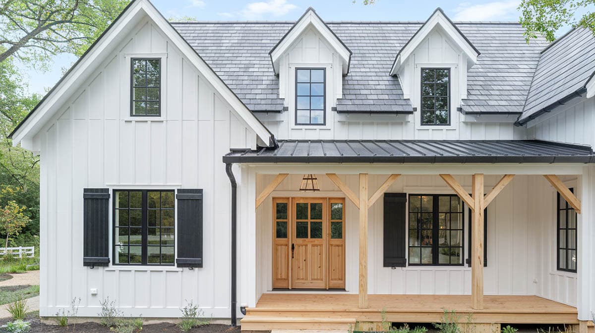 Modern farmhouse exterior with crisp white siding, black window frames, shutters and door hardware