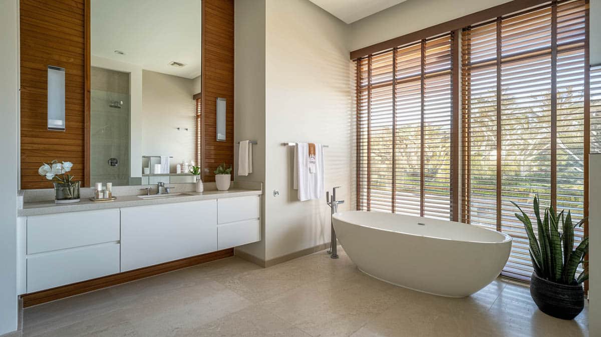 Contemporary bathroom with soaking tub and wooden blinds