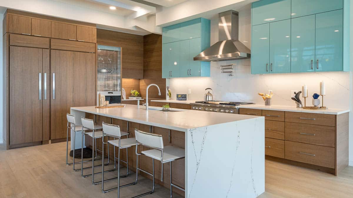 Contemporary style kitchen with wood veneer and turquoise for cabinets with white veined quartz waterfall countertops