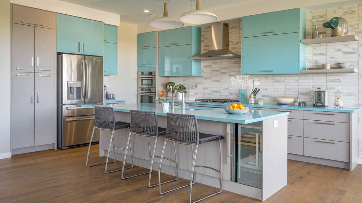 Modern kitchen with light gray upper and turquoise lower cabinets with solid surface countertops