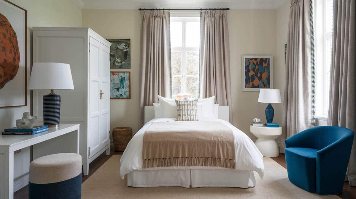 Stylish small bedroom with ivory curtains white bed and beige blanket