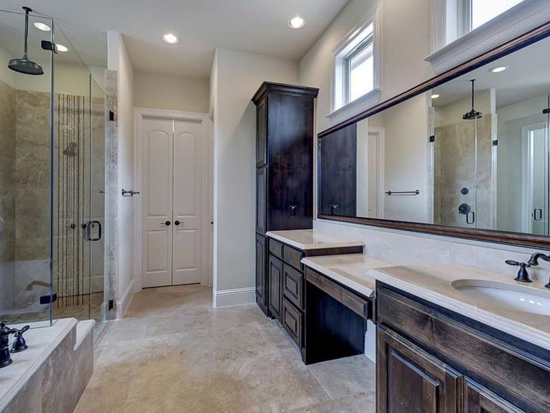 Dark vanity master bathroom with walk-in shower